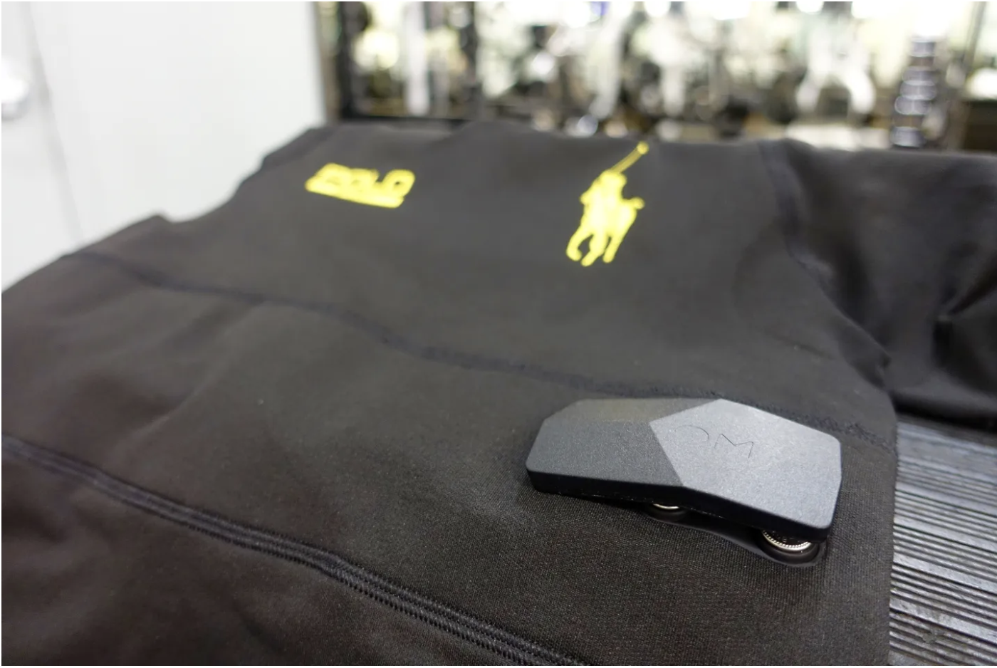 A close up of the device in the Ralph Lauren PoloTech shirt